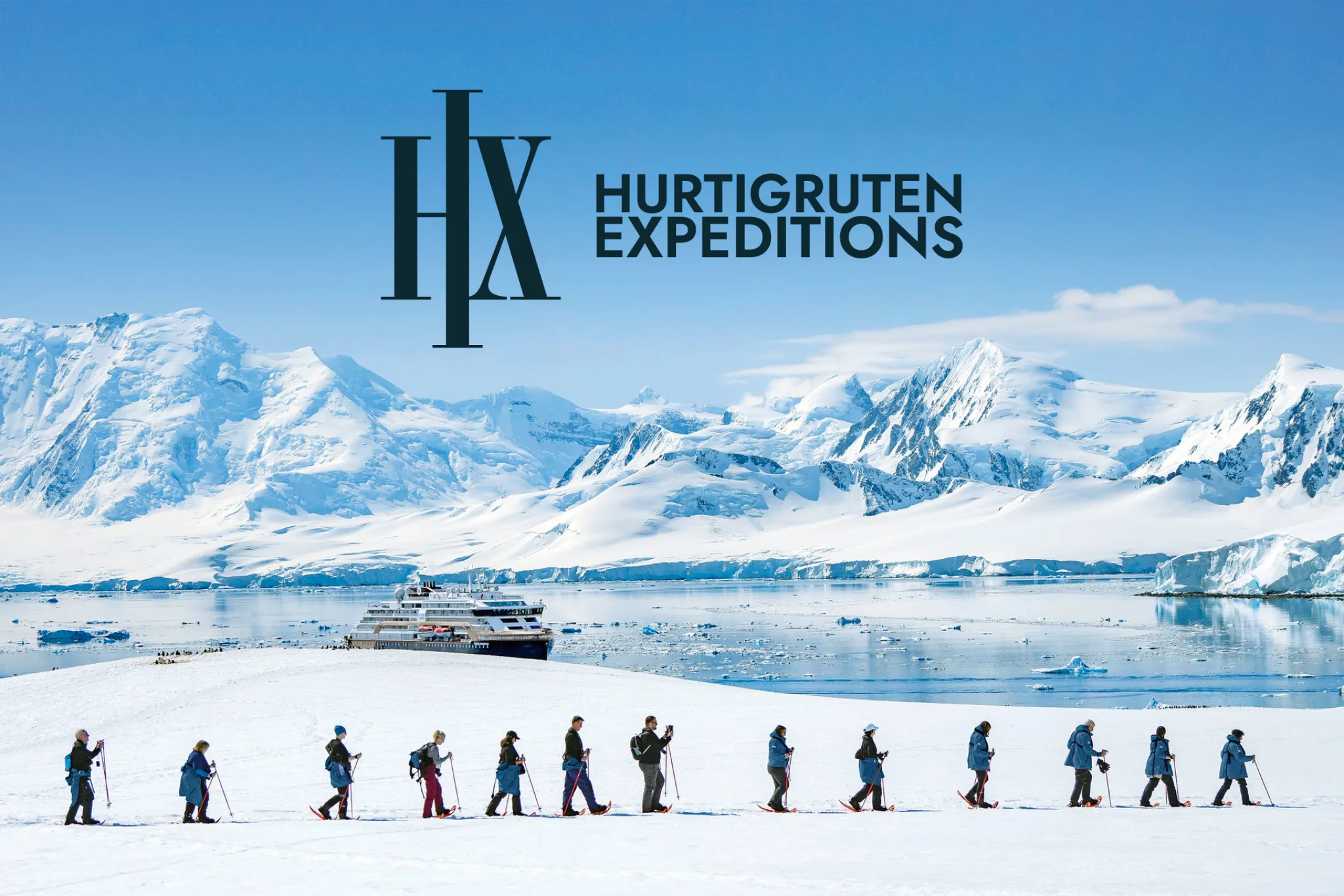 HX Expeditions Schiff vor Bergen fotografiert mit Logo
